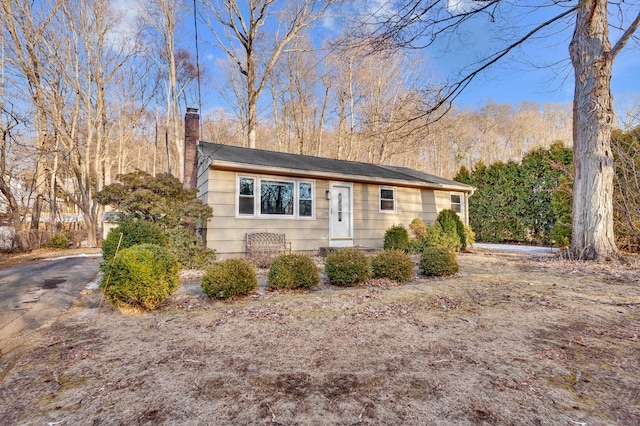 single story home featuring a chimney