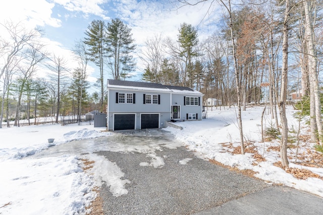 raised ranch featuring driveway and an attached garage