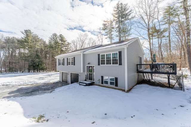 split foyer home with a deck and an attached garage