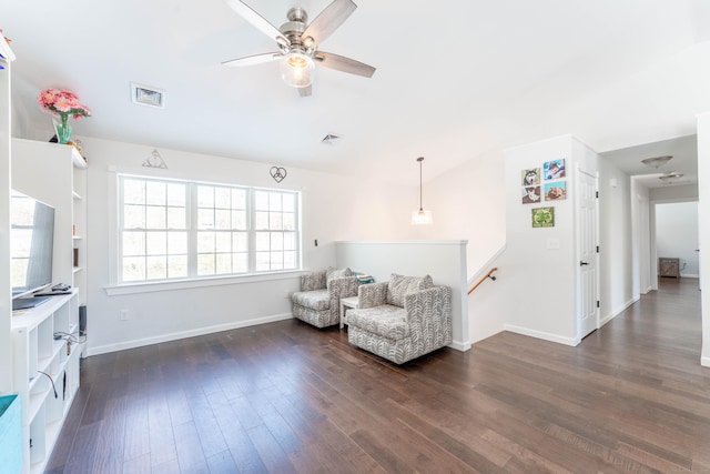 sitting room with visible vents, dark wood-type flooring, a ceiling fan, an upstairs landing, and baseboards