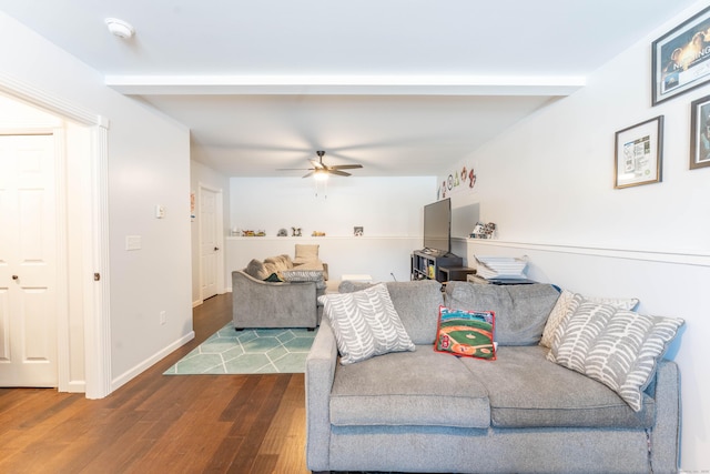 living room with baseboards, a ceiling fan, wood finished floors, and beamed ceiling