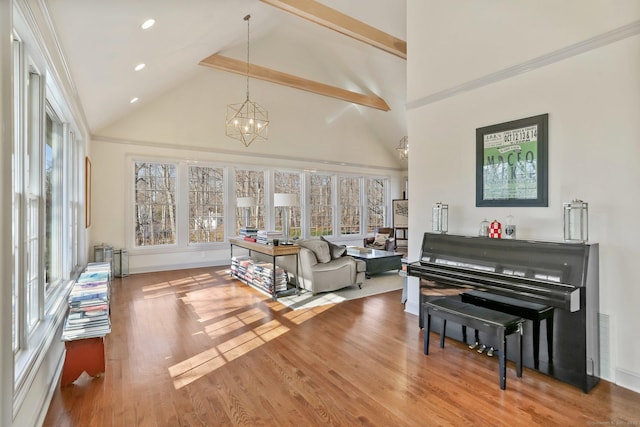 living area with a notable chandelier, high vaulted ceiling, wood finished floors, and recessed lighting