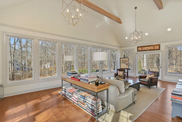 sunroom / solarium with a chandelier and vaulted ceiling with beams