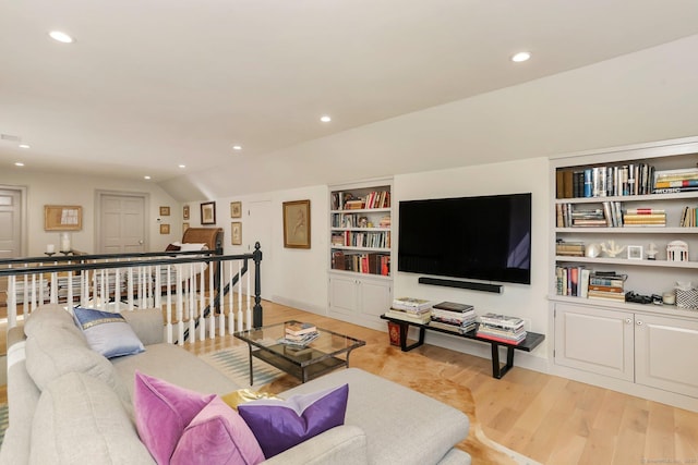 living area with lofted ceiling, light wood finished floors, and recessed lighting