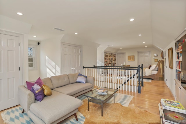 living room featuring recessed lighting, visible vents, and light wood finished floors