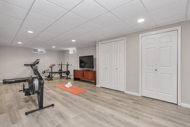 workout room with recessed lighting, a drop ceiling, baseboards, and wood finished floors