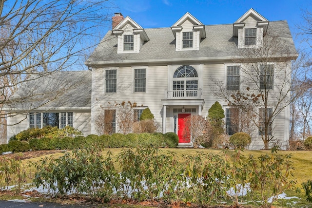 view of front of home with roof with shingles and a chimney