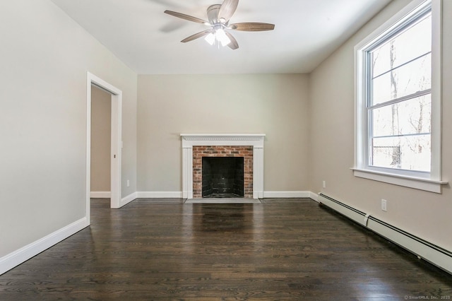 unfurnished living room featuring baseboards, dark wood finished floors, a baseboard radiator, ceiling fan, and a brick fireplace