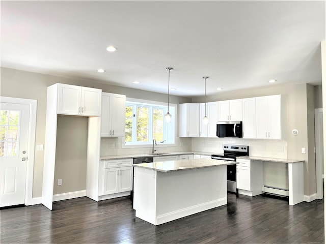 kitchen featuring stainless steel appliances, a baseboard radiator, white cabinets, and a sink