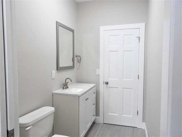 157R Sumner Wood Rd, Durham, CT 06422 - bathroom with toilet, baseboards, and vanity