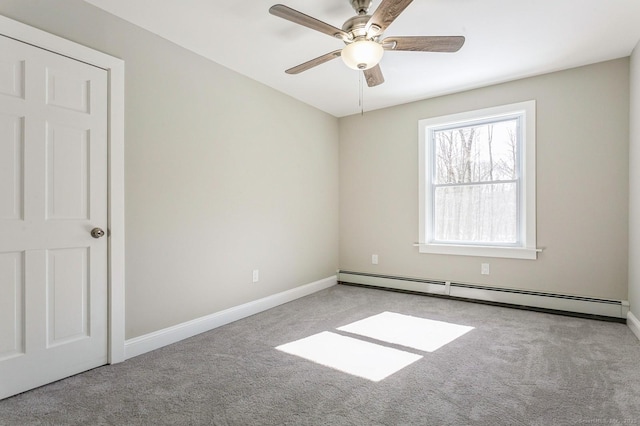 carpeted empty room with baseboards, ceiling fan, and baseboard heating