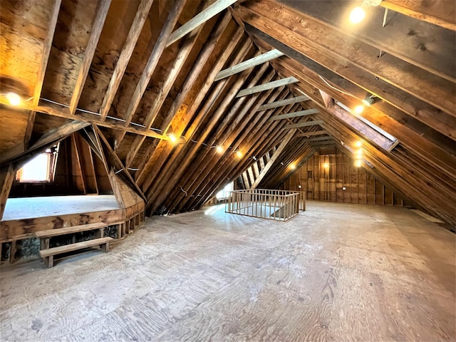 unfinished attic featuring an upstairs landing