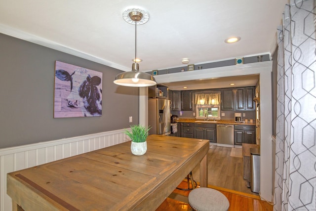 dining room with recessed lighting, wainscoting, and wood finished floors