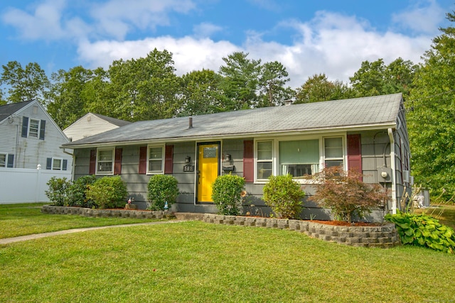 ranch-style house with fence and a front lawn