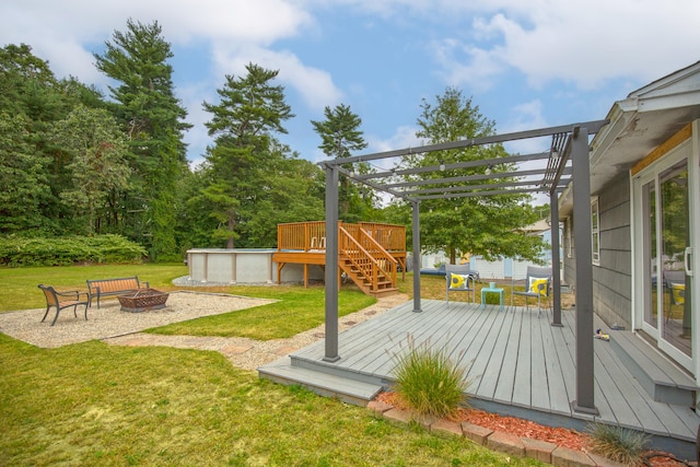 wooden terrace with an outdoor fire pit, a pergola, a lawn, and an outdoor pool