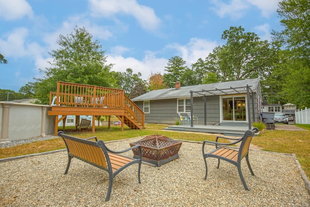 back of house with a fire pit, stairway, a wooden deck, a pergola, and a chimney