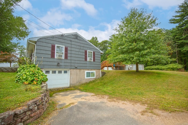 view of front of property with a garage, driveway, and a front lawn