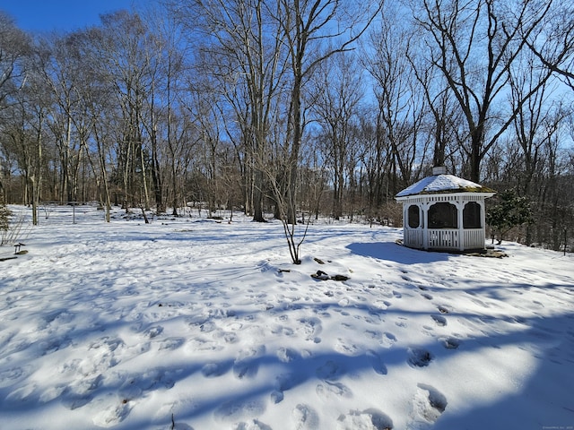 snowy yard featuring a gazebo