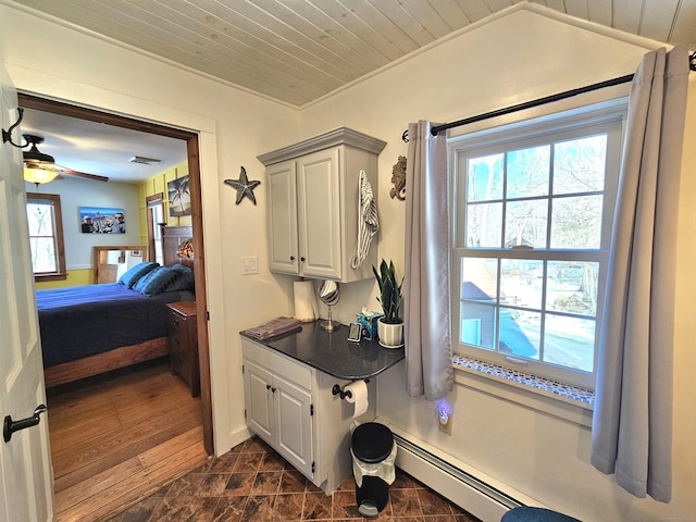 bathroom with ceiling fan, a baseboard heating unit, wood finished floors, visible vents, and wood ceiling