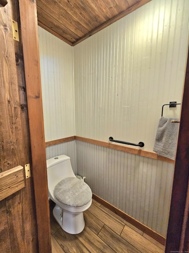 bathroom featuring toilet, wood ceiling, and wood finished floors