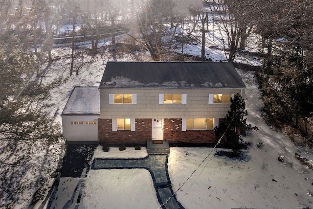 view of front of house featuring a garage and brick siding