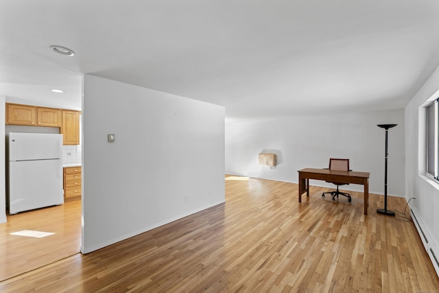 interior space featuring recessed lighting, a baseboard radiator, and light wood-style floors