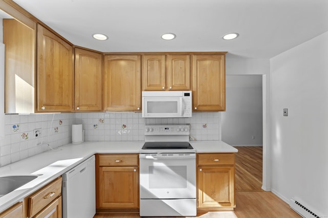 kitchen with light countertops, light wood-style flooring, decorative backsplash, baseboard heating, and white appliances