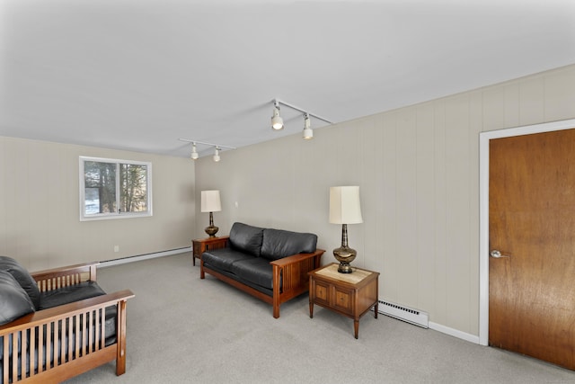 living room featuring light carpet, a baseboard radiator, and track lighting