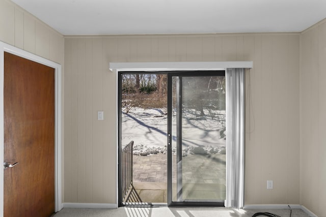 doorway with carpet and baseboards