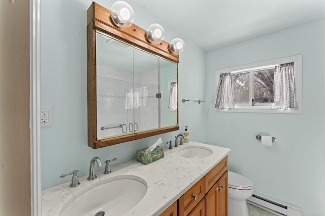 bathroom featuring double vanity, a baseboard radiator, a sink, and toilet