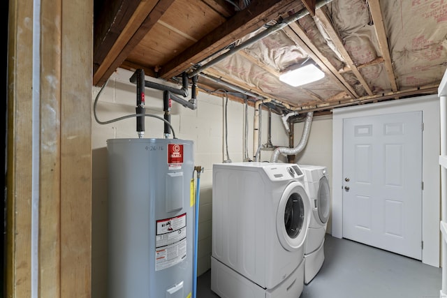 washroom with laundry area, water heater, and separate washer and dryer