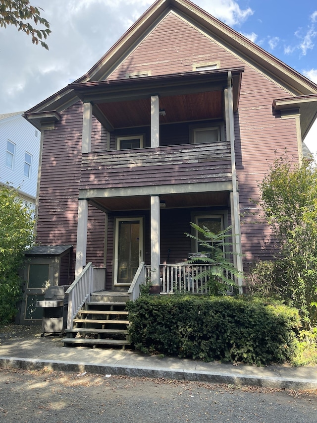 view of front of home with covered porch and a balcony