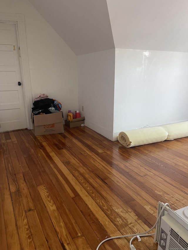 bonus room with lofted ceiling and wood finished floors