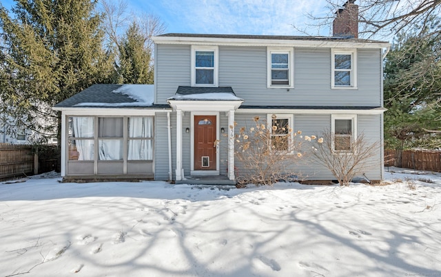 view of front of house with fence and a chimney