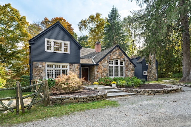 traditional home with a chimney and fence