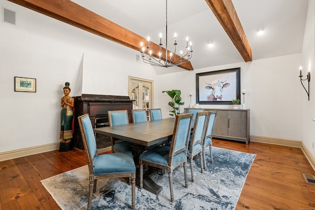 dining space with lofted ceiling with beams, dark wood-style flooring, visible vents, and baseboards