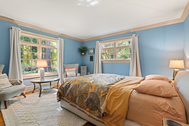 bedroom featuring light wood-style flooring and crown molding