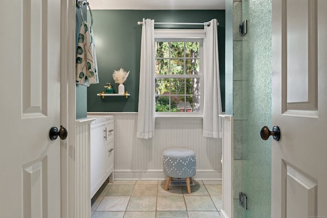 entryway featuring a wainscoted wall and light tile patterned floors