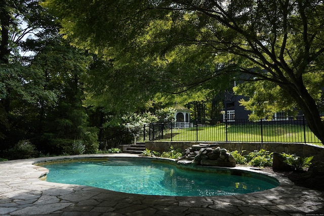 view of swimming pool with a fenced in pool, a yard, and fence