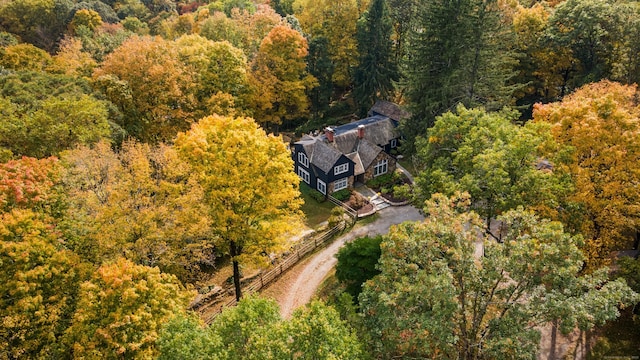 birds eye view of property with a view of trees