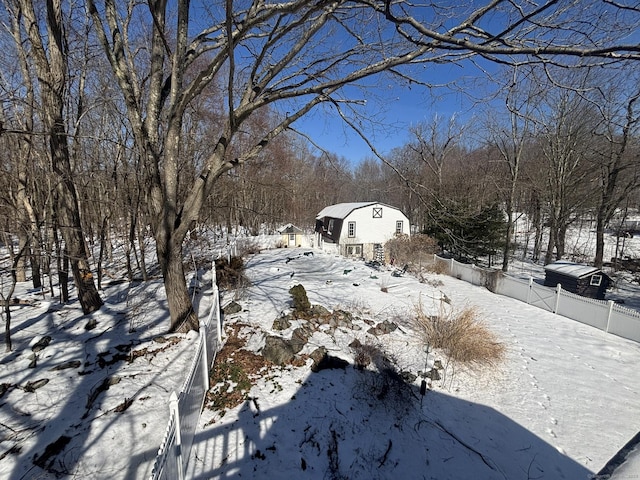 yard layered in snow with fence