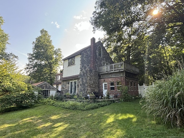 back of house with a yard and a chimney