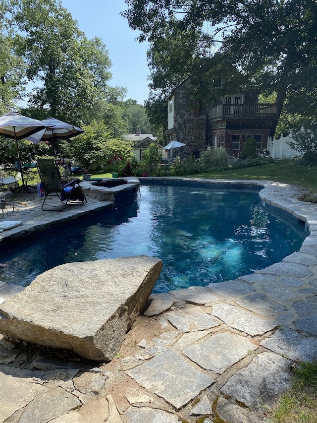 outdoor pool with a patio area