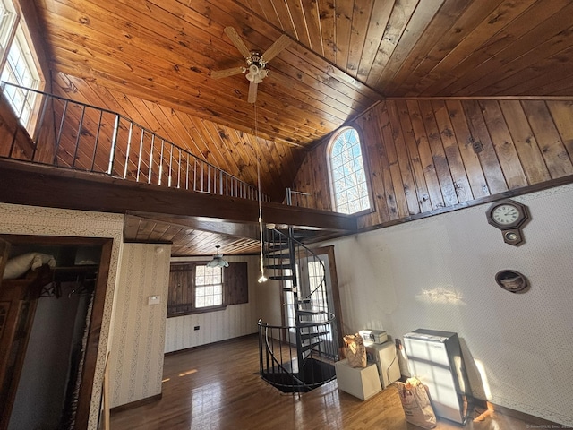 interior space featuring wood ceiling, ceiling fan, wood finished floors, stairs, and high vaulted ceiling