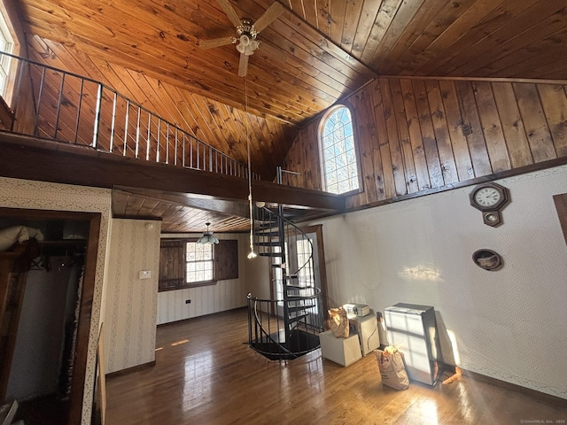 living area featuring high vaulted ceiling, wooden ceiling, wood finished floors, a ceiling fan, and stairway