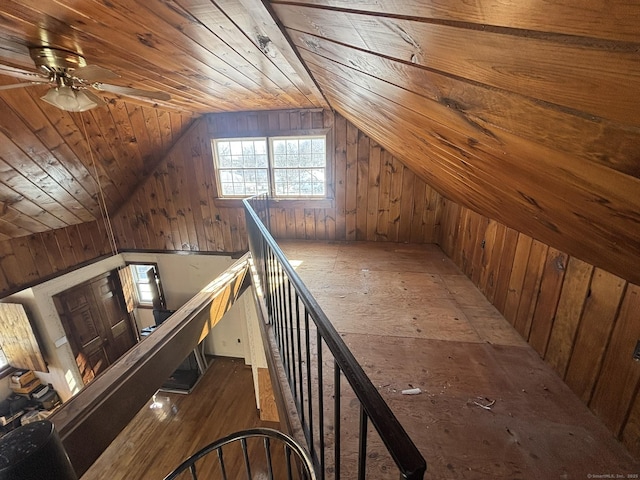 interior space with vaulted ceiling, wood walls, wooden ceiling, and wood finished floors