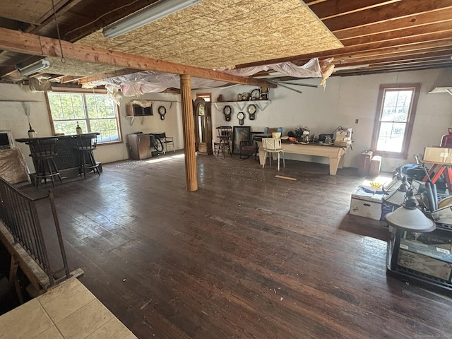 below grade area featuring a dry bar, hardwood / wood-style flooring, and a healthy amount of sunlight