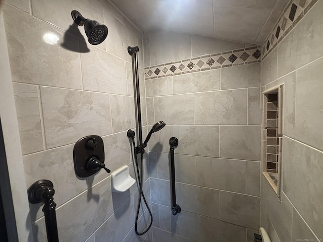 interior details featuring tiled shower