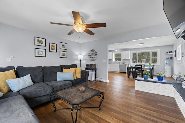 living room with ceiling fan, baseboards, baseboard heating, and wood finished floors