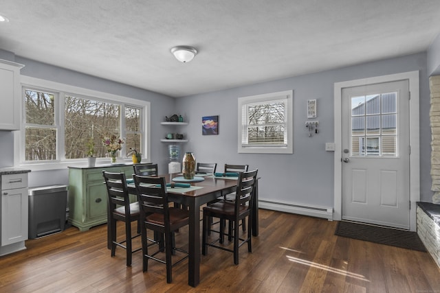 dining space with a baseboard radiator, a textured ceiling, and dark wood-style flooring